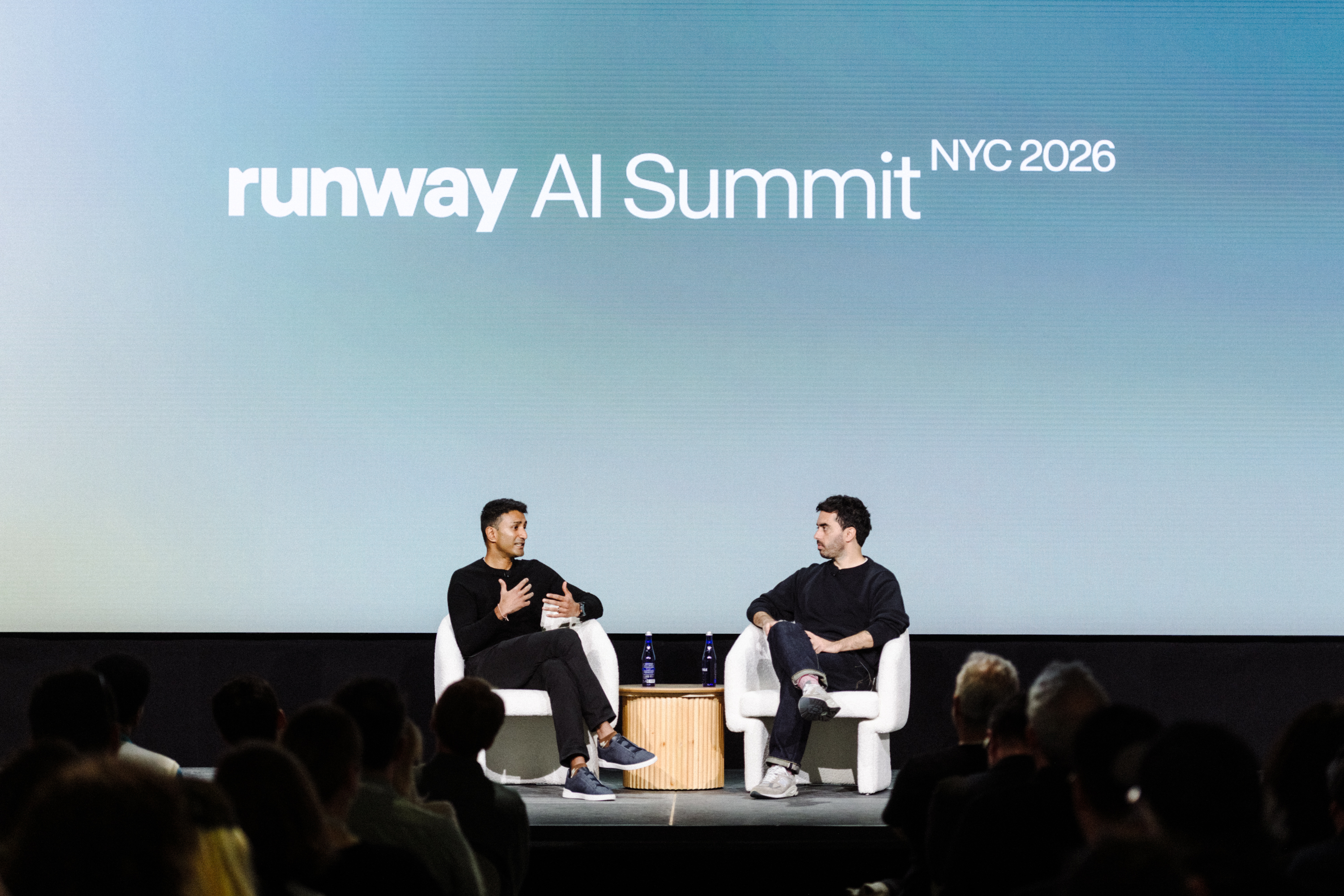 Runway AI Summit 무대에서 두 연사가 대화 중인 장면 사진.